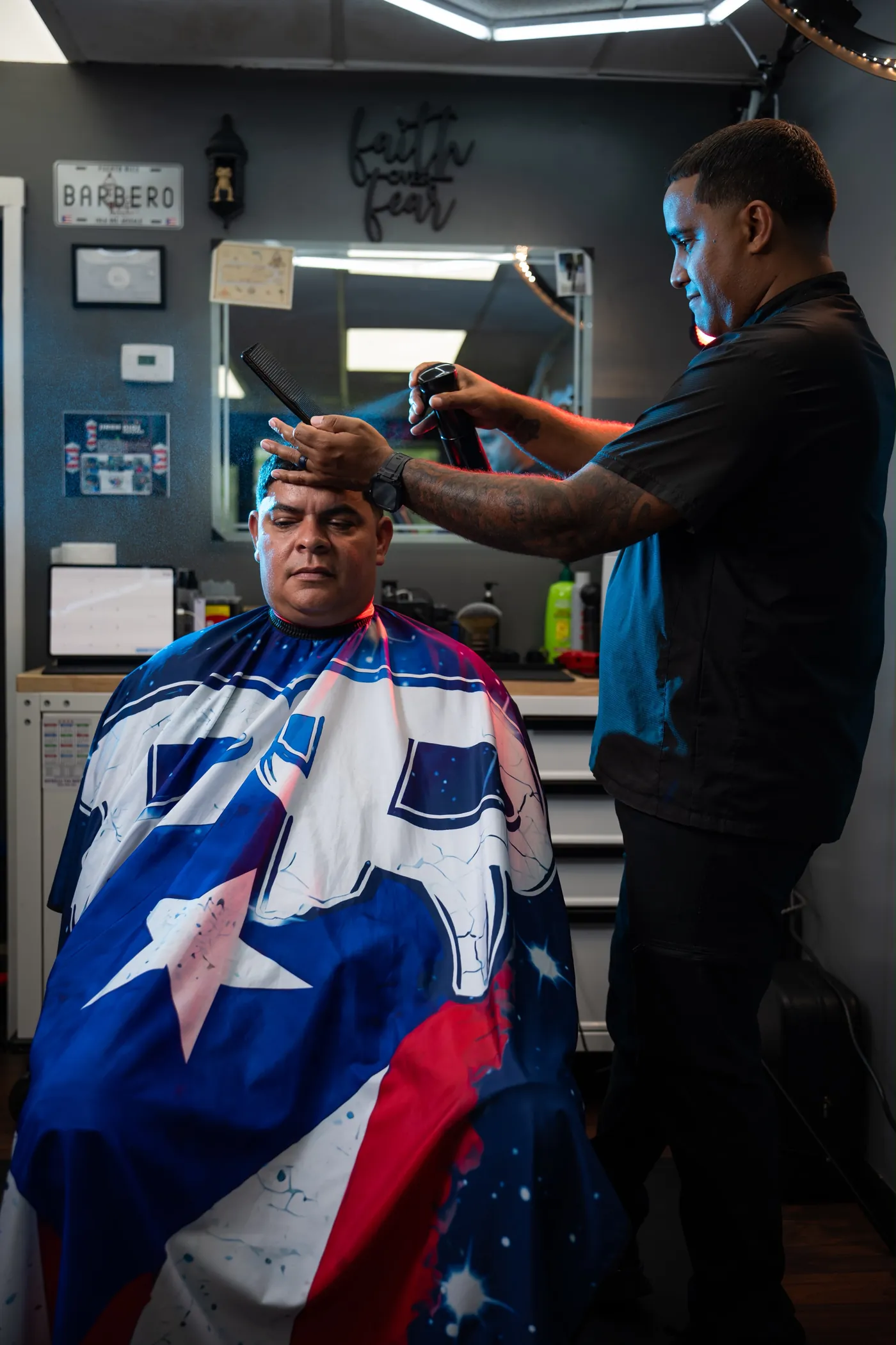 Milton Leyro styling a client's hair at Jireh Dios Proveerá Barbershop in Rochester, NY